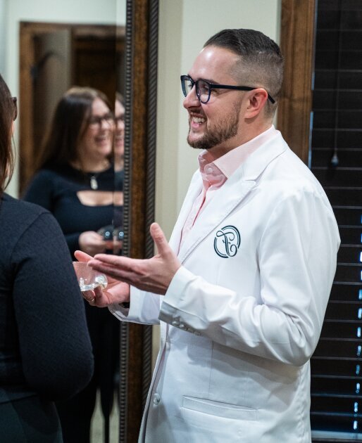 Reading Plastic Surgeon Dr. Matthew Hagan talking with patient with brown hair